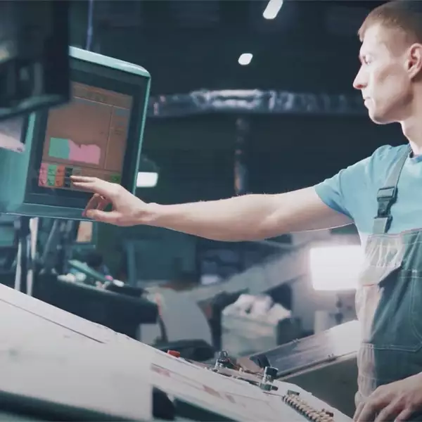 Factory worker in front of computer